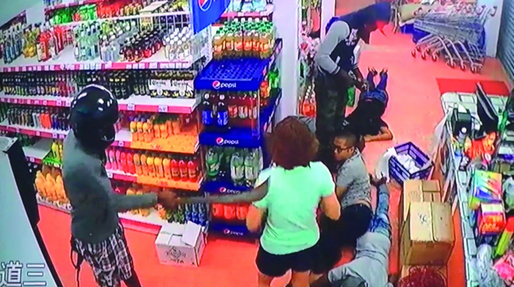 The two armed bandits carrying out the robbery