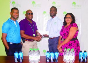 Assistant Director of Sport Brian Smith receives the sponsorship package from Banks DIH Water Beverage Manager Clive Pellew while Errol Nelson and Ms Sooklall of the NSC look on