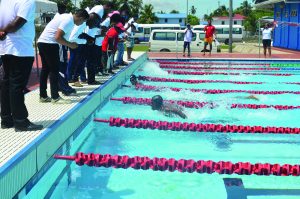 Hannibal Gaskin (far right) looks over his shoulder after a fierce  battle with Jair Telting in the 50m Fly (Akeem Greene Photo) 