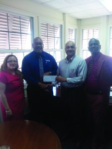 President of Lusignan Golf Club Oncar Ramroop (second from right) receives the sponsorship cheque from Demerara Mutual Assurance Company, Geoffrey Brewster in the presence of representatives from LGC and Demerara Mutual Assurance