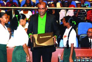 Then President Bharrat Jagdeo presenting a laptop to students of the Abrams Zuil Secondary School, at the launch of the One Laptop Per Family initiative in January 2011 