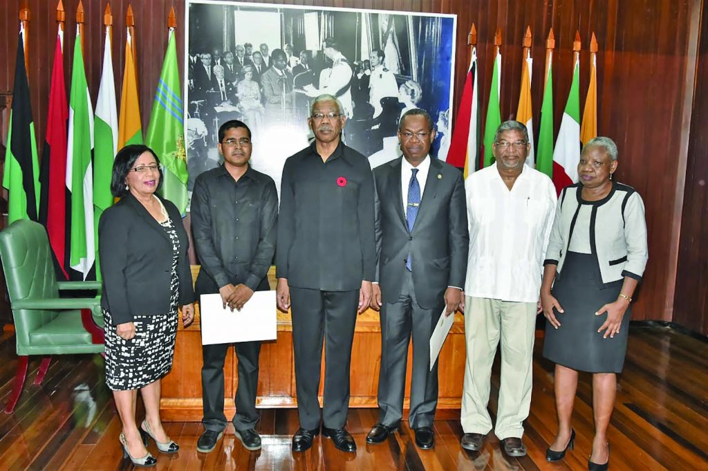 Members of the new Public Procurement Commission pose with President David Granger at the Ministry of the Presidency on Friday 