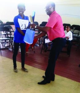 ‘A’ Division Commander Clifton Hicken hands over a prize to one of the winners at the conclusion of the competition   