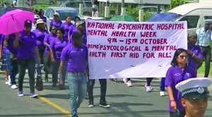 Participants march in observance of Mental Health Week being held in New Amsterdam