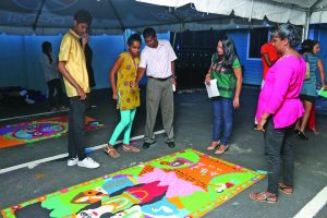 RGI Manager Surida Nagreadi along with offical from Distribution Service Limited (DSL) during the judging of the Rangoli on Friday at DSL’s location on Sheriff Street, Georgetown 