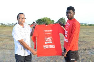 Anthony Price donating branded jerseys to the Number 28 Village football team 