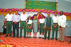 Social Cohesion Minister Amna Ally along with Regional Chairman Devanand Ramdatt and Regional Executive Officer Rupert Hopkinson pose with teachers, and the top five 2016 CSEC best performing students of the Anna Regina Secondary School 