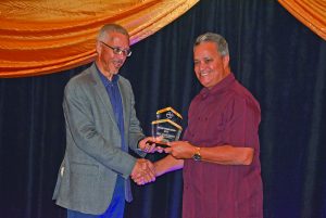 Captain Gerry Gouveia receives the award for Tourism Entrepreneur of the Year from Business Minister Dominic Gaskin