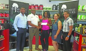 Clive Pellew (second left) of Banks DIH presents his company’s sponsorship package to Noshavyah King in the presence of (from left) Errol Nelson, Jordana Ramsay-Gonsalves and Jamie McDonald
