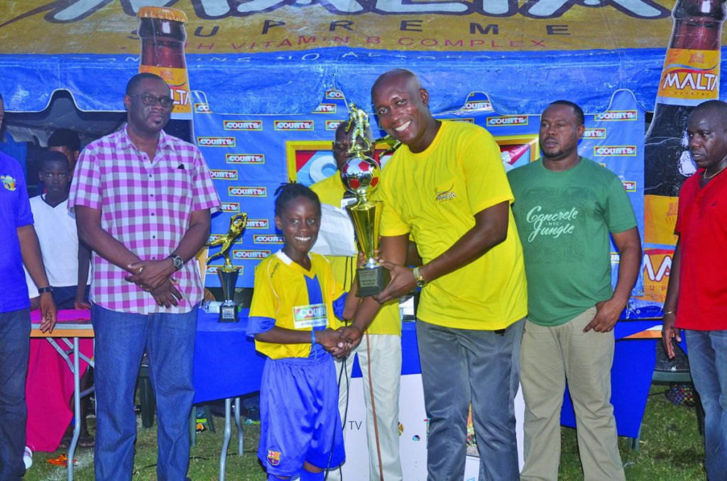 Seon  Cato receives his  highest goal scoring trophy from Banks DIH  Non- Alcoholic Brand  Manger Clayton McKenzie
