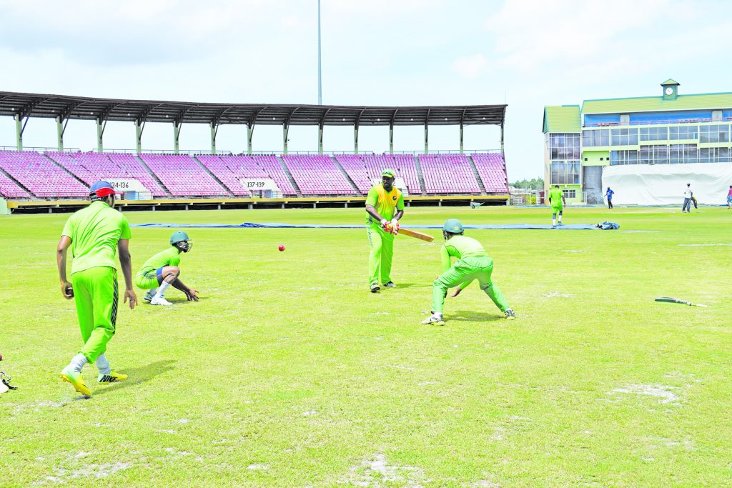 Jaguars Head Coach, Esuan Crandon (with bat) and Vice-Captain Vishaul Singh (left) going through close catching drills with Shimron Hetmyer and Tagenarine Chanderpaul 