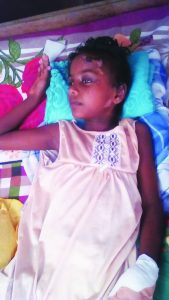 Seven-year-old Padmini Patram lies helpless on her bed 