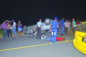 The lifeless body of the unidentified driver of a silver Toyota Premio motor car on the Parfaite Harmonie New Road, where the two-vehicle smash-up occurred  
