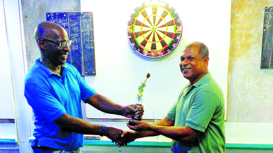 Dr. Terrence Joseph presenting Lallchand Rambharose with his award