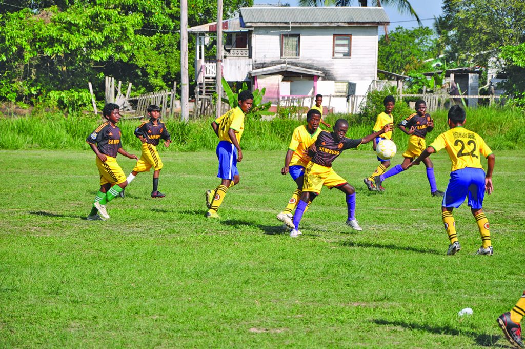 There is a keen tussle for possession between Diamond United and Circuit Ville Jaguars at the Grove Playfield