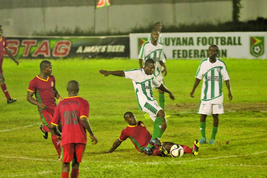 Part of the intense action between The Guyana Defence Force (red) and Victoria Kings (Marceano Narine Photo)