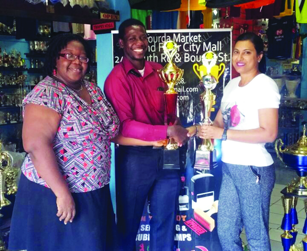  Devi Sunich of Trophy Stall presents the symbolic Doubles Trophies to GLTA executives, Secretary Oswin Coggins and Junior Participation Chair Grace McCalman