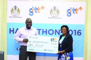 GTT CEO Justin Nedd presents a cheque in support of the Hackathon