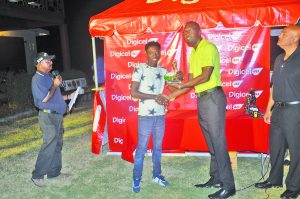 Surinamese Ridel Doekoe receiving his third-place trophy from Director of Sports, Christopher Jones 