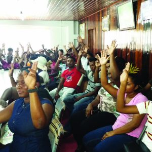 Region Two residents raise their hands in support 