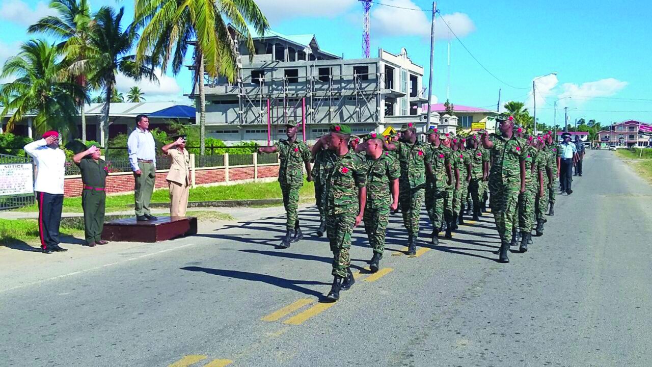 Region Two Chairman Devanand Ramdatt taking the march past salute in observance of Remembrance Day 