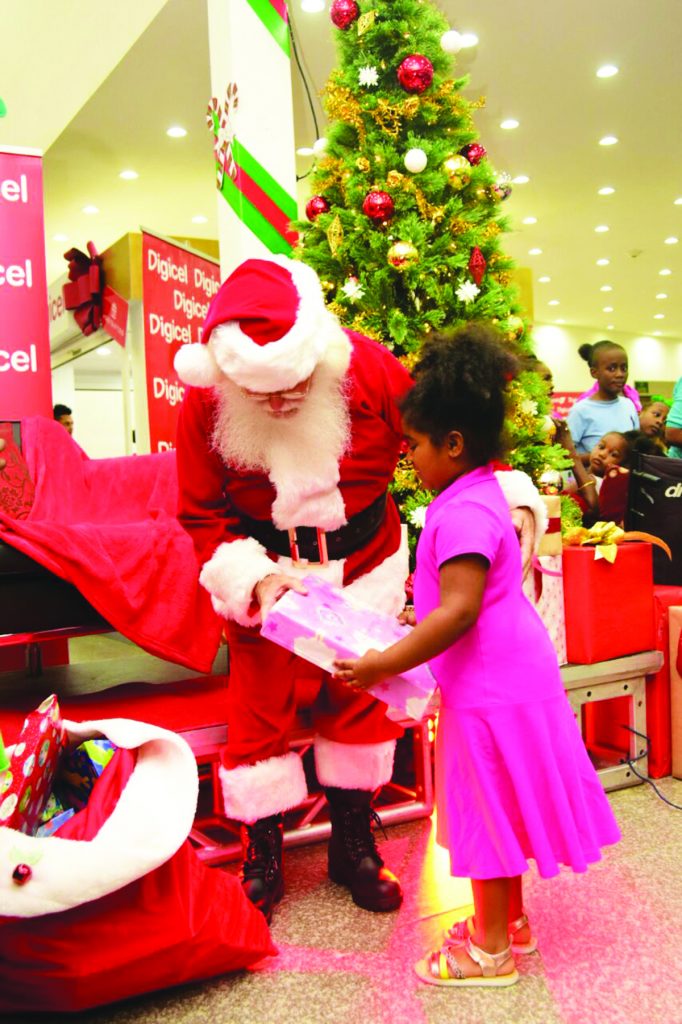 A student of the Gifted Hands Special Needs School receives gifts from Santa Claus 