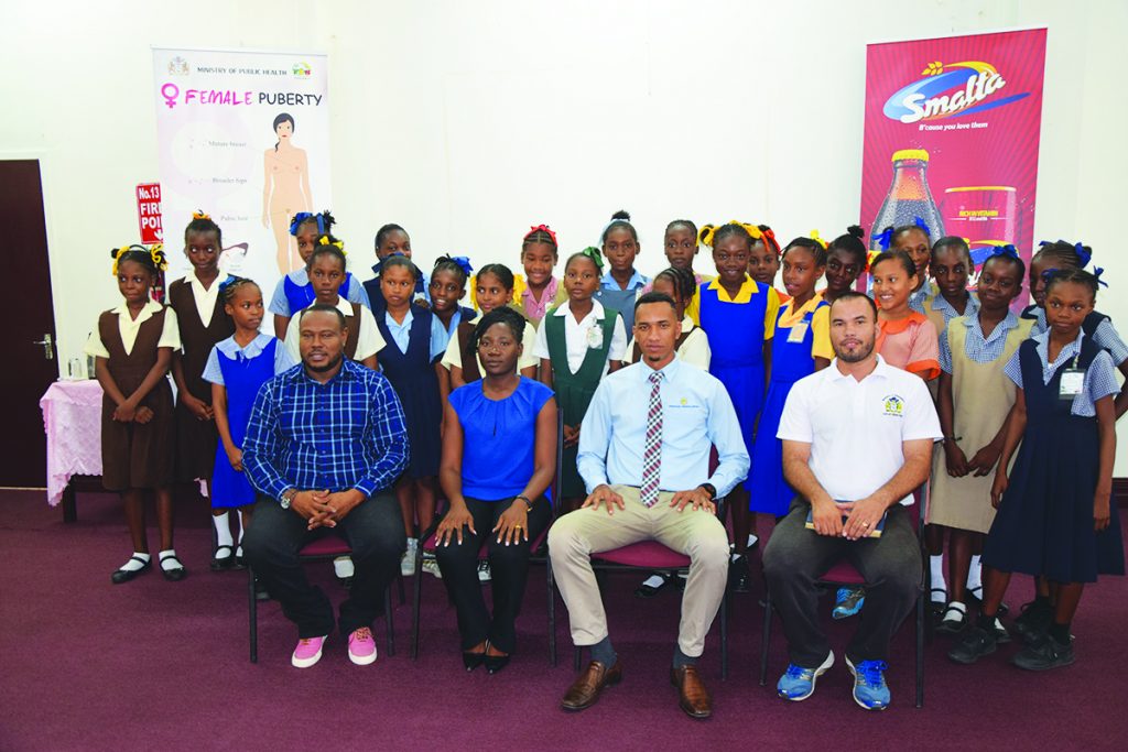 (L-R) Co-Director of the Petra Organisation, Troy Mendonca; Health Officer of the Public Health Ministry, Joy Gravesande; Smalta Representative Sean Abel and Head of Physical Education Department of the Education Ministry Nicholas Fraser along with some of the  girls of  the  participating schools  