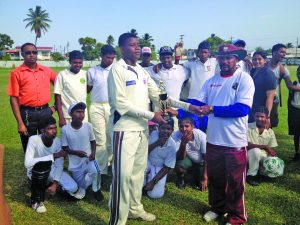 Captain of Saraswat Secondary receives the zone champion trophy from Dhanpaul (right)