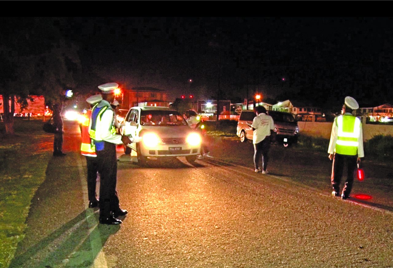 GNRSC members distributing road safety paraphernalia and briefly chatting with drivers 