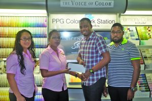 Bumper to Bumper Services’ Adiola Cordis handing over the sponsorship to Aubrey Major Jr in the presence of Kenrick Noel (extreme right) and Janet Alphonso 