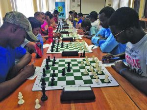 Senior chess players concentrating on their game at the National Resource Centre 