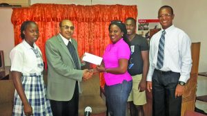 President of the GOA, KA Juman-Yassin handing over the cheque to team manager Mayfield Taylor-Trim 