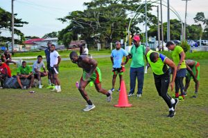 Avery Corbin (left) leads  some of the players  in fitness drills at the National Park during preparation for the championships