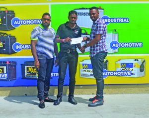  New Era’s Aubrey Major Jr receiving the sponsorship cheque from Sankar’s Auto Works representative Chandran Kumar in the presence of Kenrick Noel