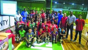 The various prize winners at the conclusion of the tournament pose with their spoils and President of the Guyana Table Tennis Association, Godfrey Munroe (2nd from right)