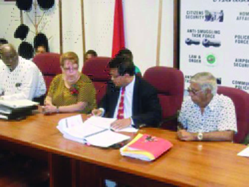 President of Western Scientific Company Edwin Mackoon (second from right) signing a contract in Guyana (GINA photo) 