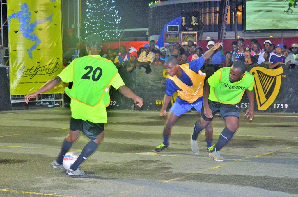 Broad Street’s Lennox Cort  (yellow bib) withstood the physical battle to score a spectacular goal in the 39th minute