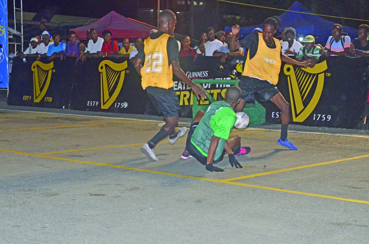 Bent Street’s Anthony Abrams is floored in his attempt for possession of the ball against the Camp Street All star team  