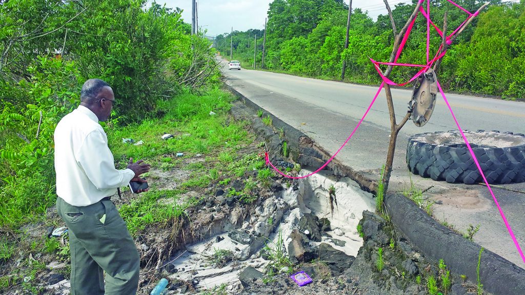 Regional Chairman Renis Morian examines the extent of road damage at Amelia's Ward 