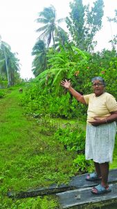 Jasmattie Kissonlall points to the condition of the main entrance into the village 