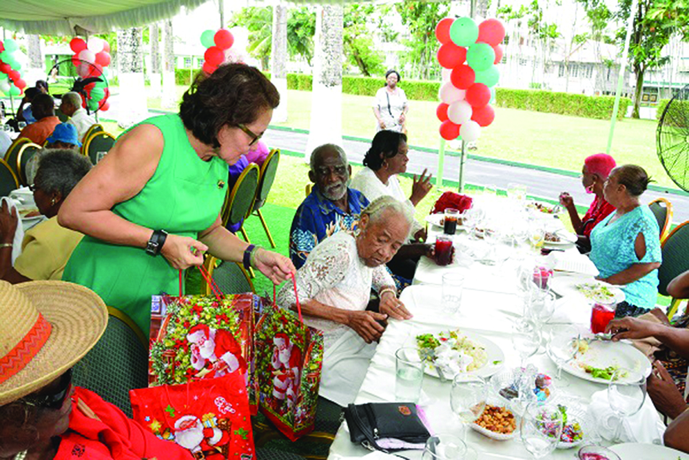 First Lady, Sandra Granger distributing gifts to the seniors at a Luncheon