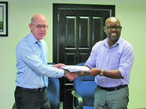DHBC General Manager Rawlston Adams (right) and Arie Mol of LievenseCSO (left) shake hands following the signing of the contract