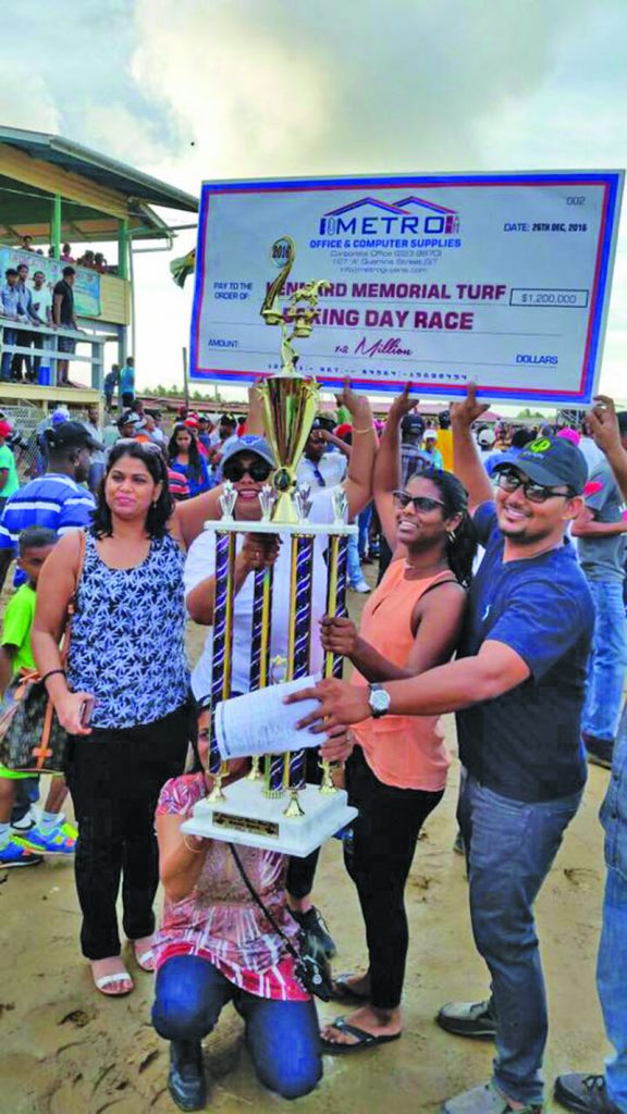 Members of the Nand Persaud Racing Stables are overjoyed upon receiving the top spoils on Boxing Day  