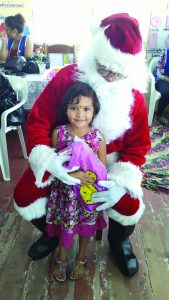 This little girl is happy to receive a gift from Santa