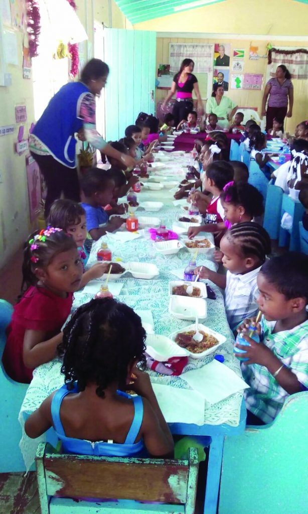 The children enjoying their treats, compliments of the Essequibo Leo Club 