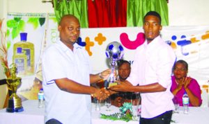 Flash back! Most Valuable Player of the inaugural tournament, Clarence Huggins (right) of Milerock FC collecting the award for Most Valuable Player from Dwayne Lovell