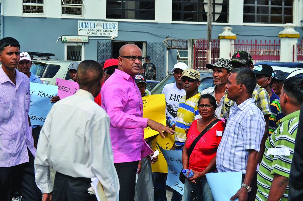 Opposition Leader Bharrat Jagdeo interacting with protesters outside the National Assembly on Monday