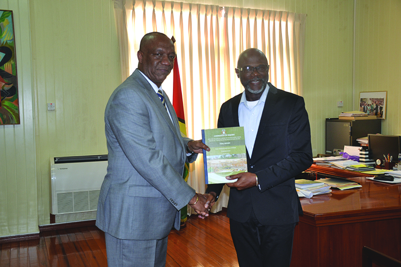 Minister of State Joseph Harmon receiving the final COI report Rear Admiral (ret’d) Gary Best on Monday  