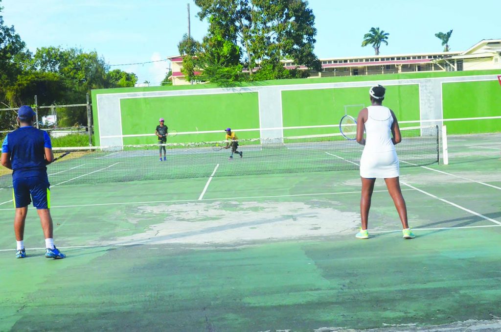 Action in the Trophy Stall Tennis Doubles Tournament on Sunday at National Racquet Centre, Woolford Avenue