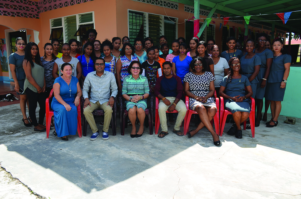 First Lady Sandra Granger (seated third from left) is flanked by facilitators and the 24 participants  